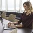 Person Working on Laptop in Conference Room